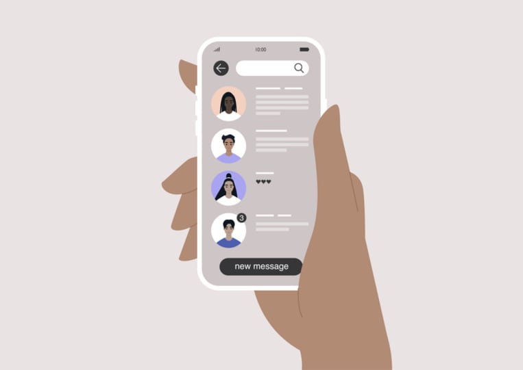 hand holding mobile phone showing direct message