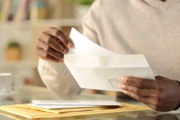 african american man holding mail in his hand